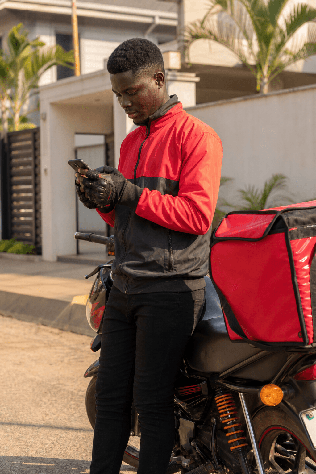 Delivery rider checking orders on his phone