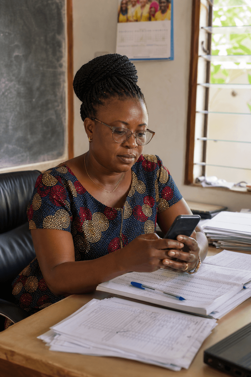 School administrator messaging parents from her office